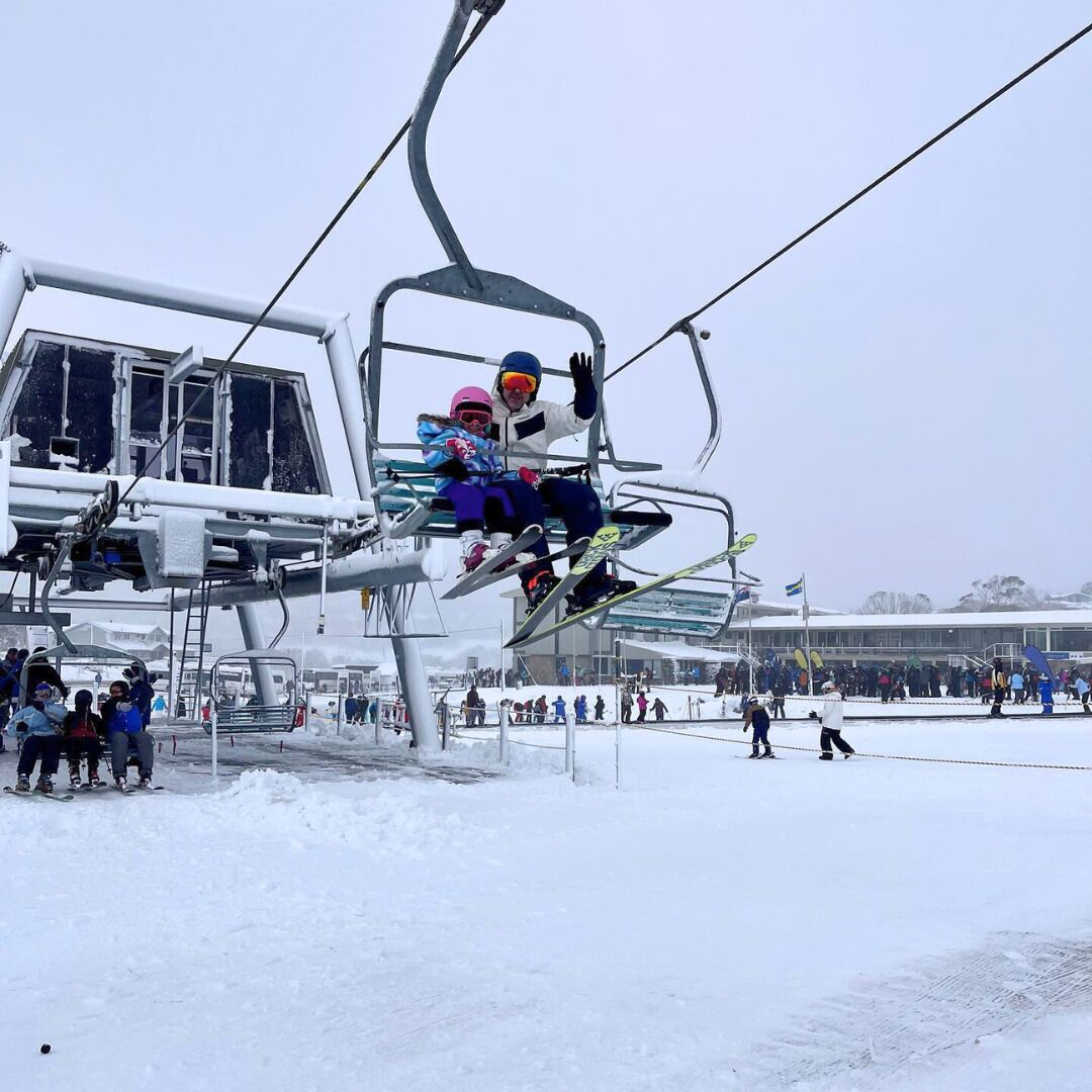 A ski lift with skiers.
