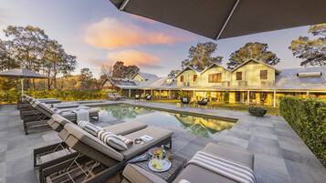 Een buitenzwembad en ligstoelen