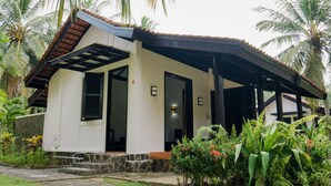 A two-story building with a sloped roof, a stone foundation, and a covered porch. - Grand Elty Krakatoa (Kalianda)