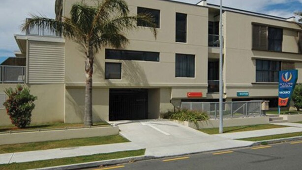 A modern hotel with a flat facade, multiple windows, and a parking lot. - Atlas Suites And Apartments (Tauranga)