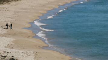 White sand, beach towels