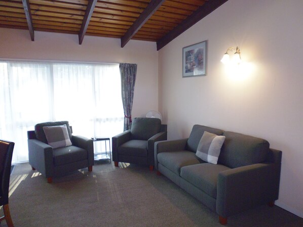 One Bedroom Apartment Downstairs | Living area | 21-inch flat-screen TV with satellite channels, TV