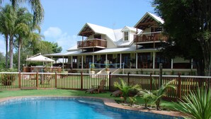 A two-story building with a swimming pool in front. - Clarence River Bed & Breakfast (Seelands)