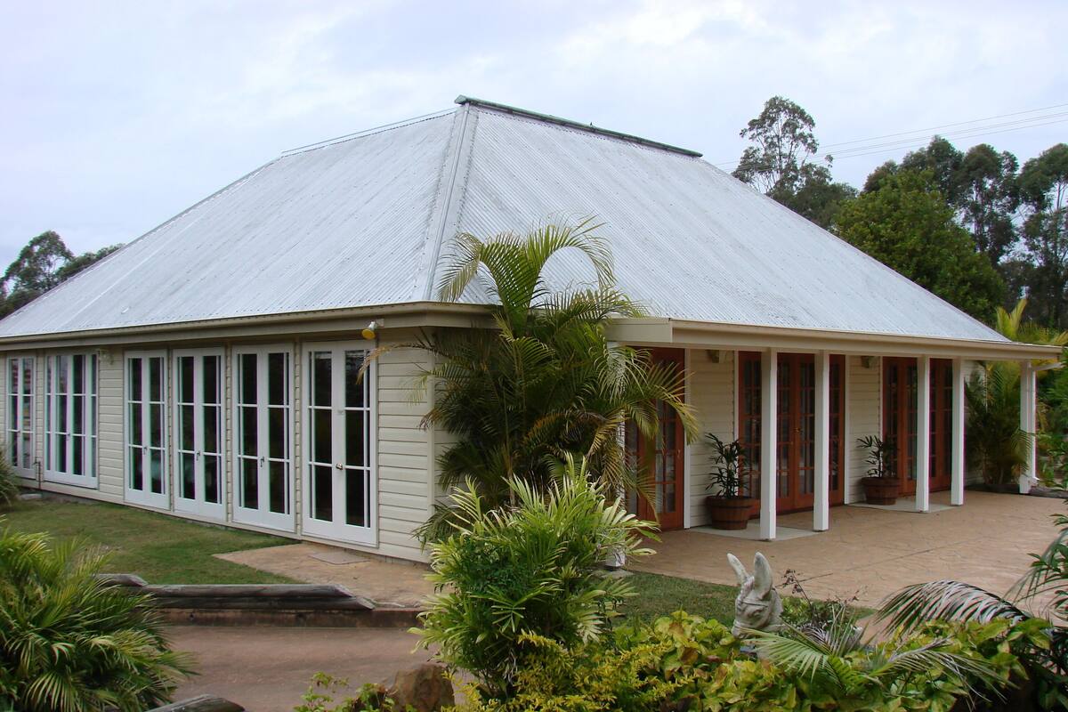 A single-story building with a gabled roof and a covered porch.