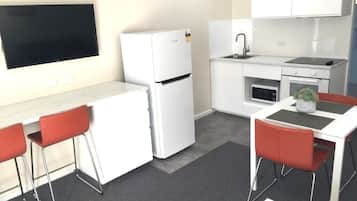 Self Contained Studio | Living area | 32-inch LCD TV with cable channels, TV