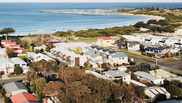 A coastal residential area with houses, a marina, and a beach.