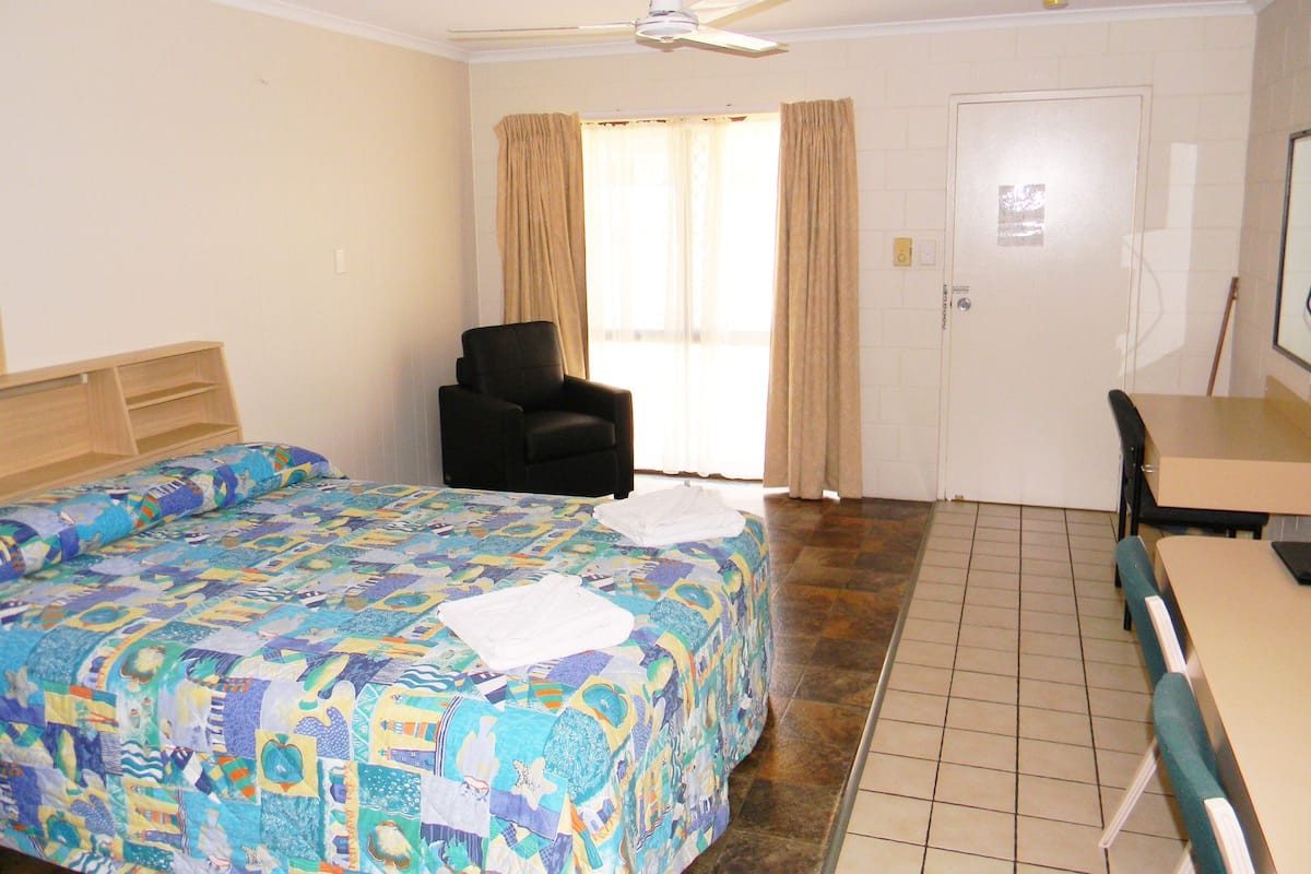 Premium bedding, desk, laptop workspace, blackout drapes