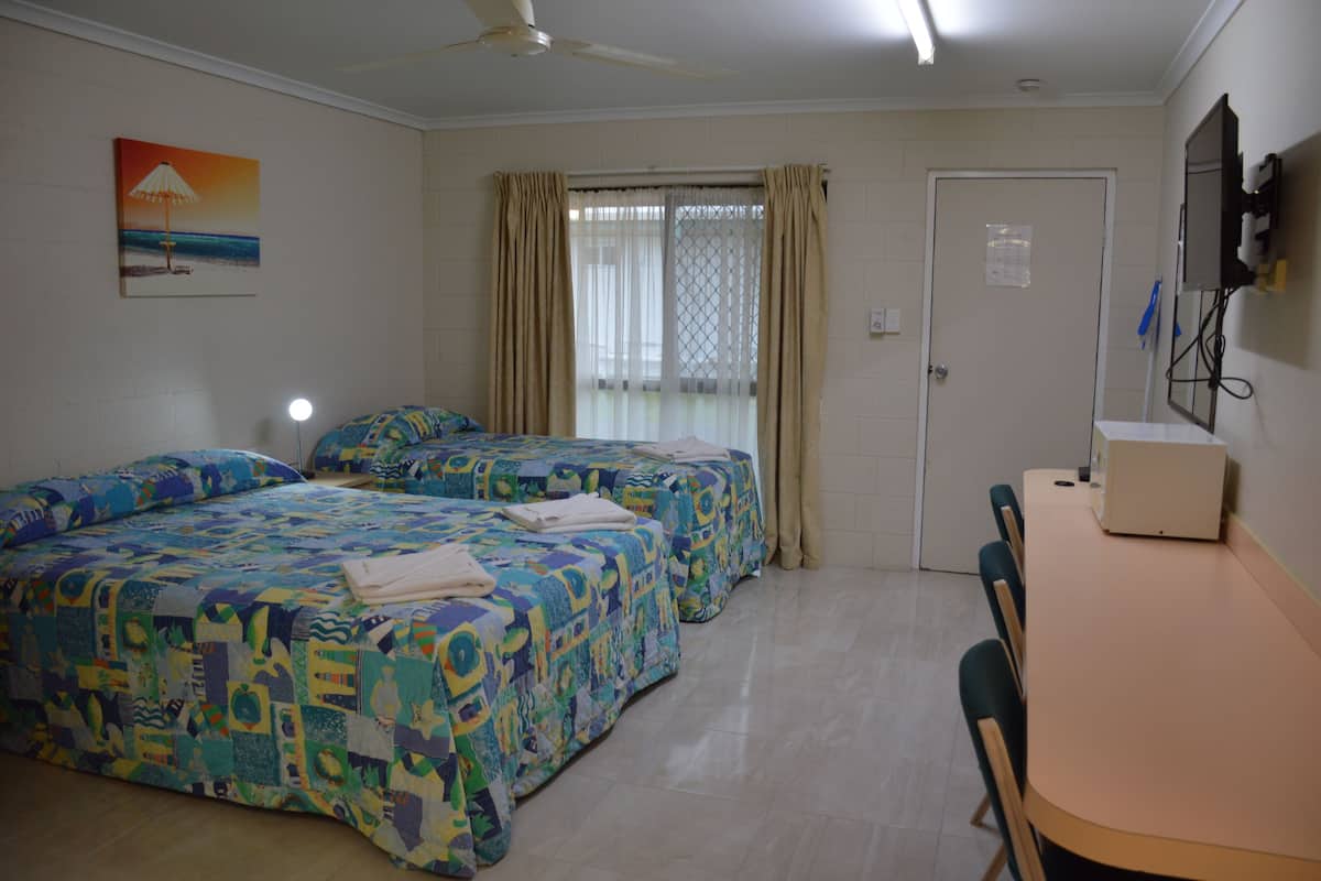 Premium bedding, desk, laptop workspace, blackout drapes