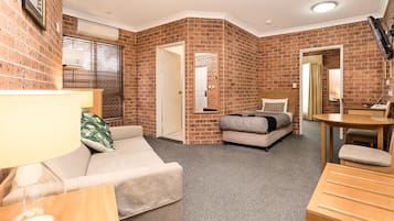 Family Suite, 1 Bedroom | Living area | 42-inch TV with satellite channels