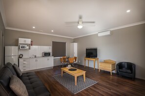 Family Apartment, 2 Bedrooms, Kitchenette | Living room | 42-inch TV with satellite channels