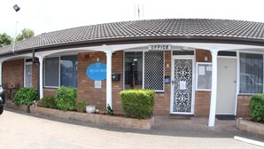 A reception area with a sign indicating an office, a reception desk, and a door marked "28".