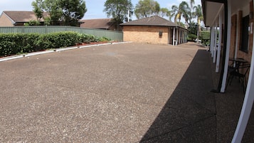 A parking lot with a building on the right.
