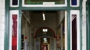 The entrance to the Australian Hotel with a green and white facade, a tiled floor, and a central archway. - Australian Hotel Boonah (Boonah)