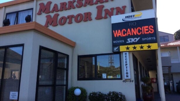 The exterior of Marksman Motor Inn with a sign indicating no vacancies and amenities like movies and sports. - Marksman Motor Inn (Wellington)