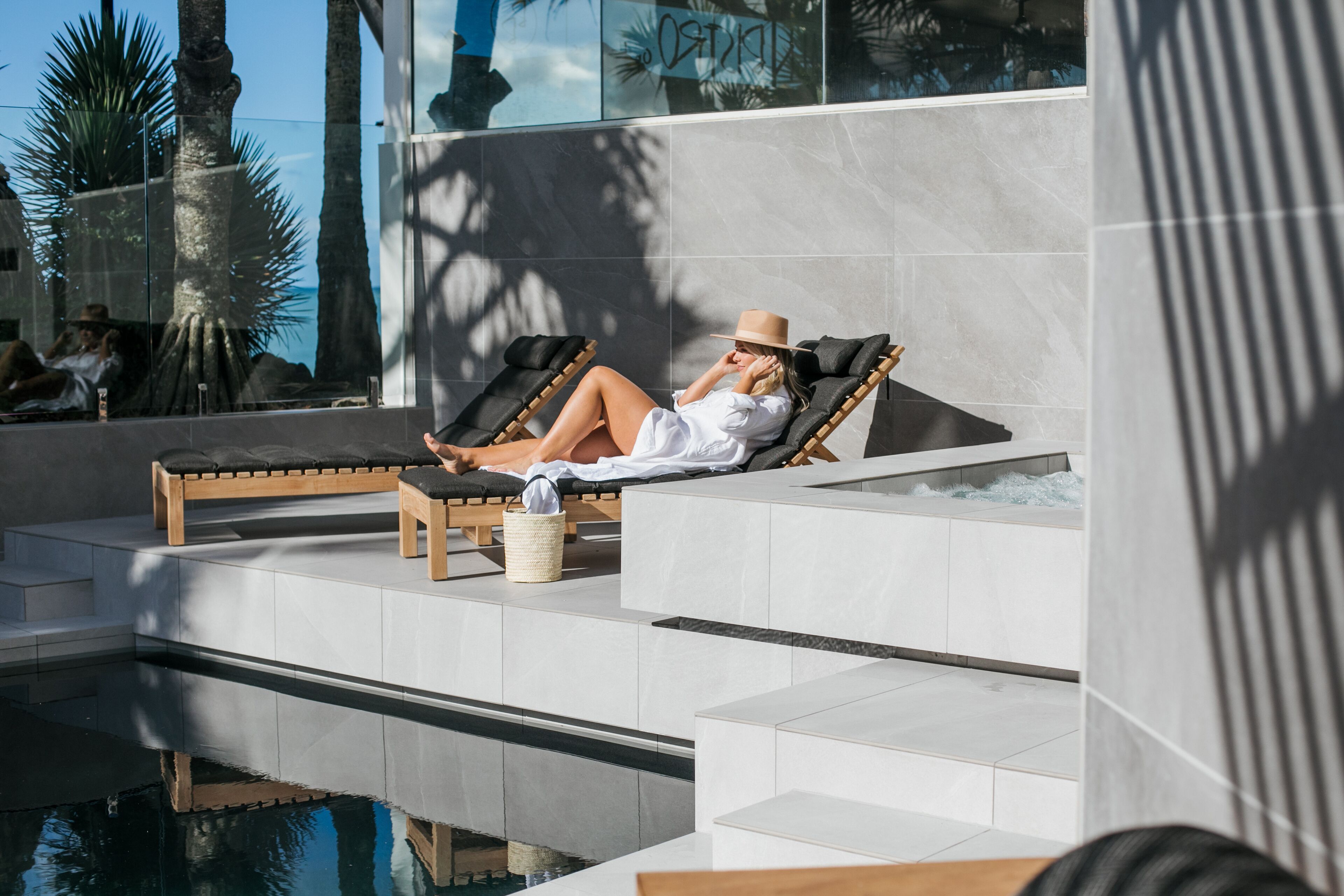 A poolside area with lounge chairs and a small table.