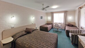 A hotel room with two single beds, a desk, a chair, and a ceiling fan. - Abraham Lincoln Motel (East Tamworth)