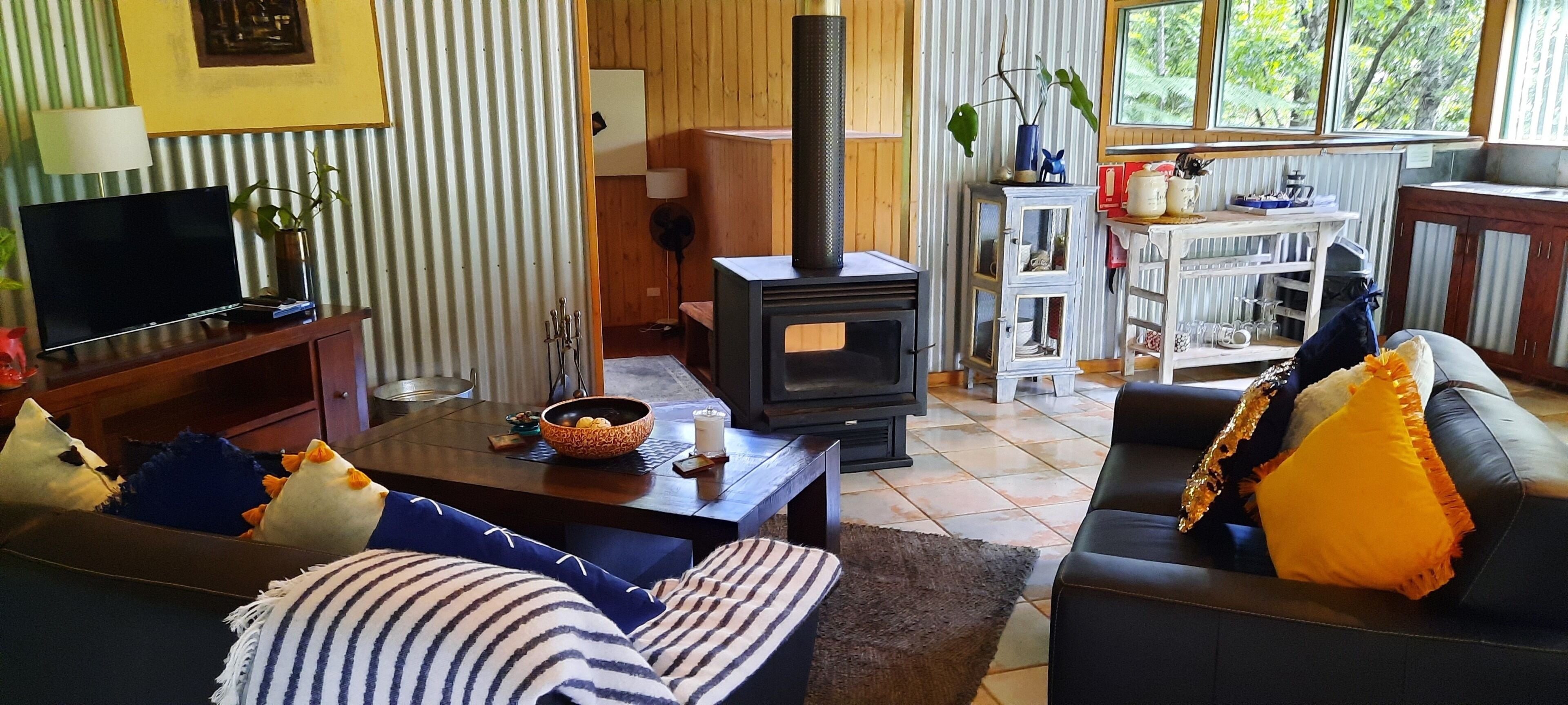 A cozy living room with a fireplace, a television, and comfortable seating.