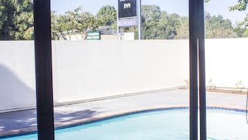 Outdoor pool, open 9:00 AM to 9:00 PM, pool loungers