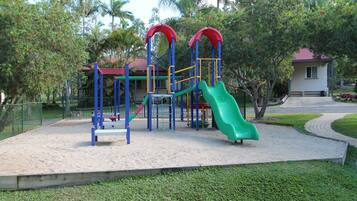 Ein Spielplatz mit Rutsche und Klettergeräten.