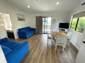 Villa Deluxe, 2 habitaciones | Zona de estar | Una televisión de pantalla plana, un reproductor de DVD, libros