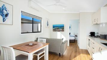 Deluxe Villa, 1 Bedroom | Living area | 26-inch flat-screen TV with digital channels, TV, DVD player