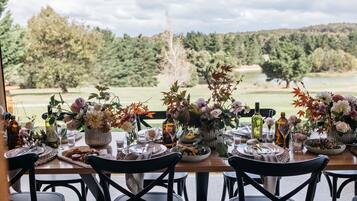 Enjoy a meal with a view of the lush landscape from this dining table.