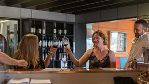 A bar area with a counter, wine bottles, and a menu. - Ridgemill Escape (Broadwater)