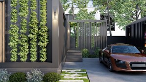 A modern building with vertical gardens, a car parked in front, and a pathway leading to the entrance. - Big4 Tasman Holiday Parks - Bright (Bright)