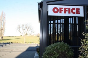 A building with a sign that reads "OFFICE" on the front. - Ashbury Park Motel (Timaru)