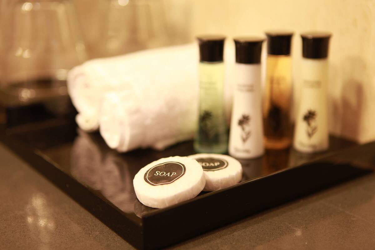 A tray with soap bars and a rolled towel.