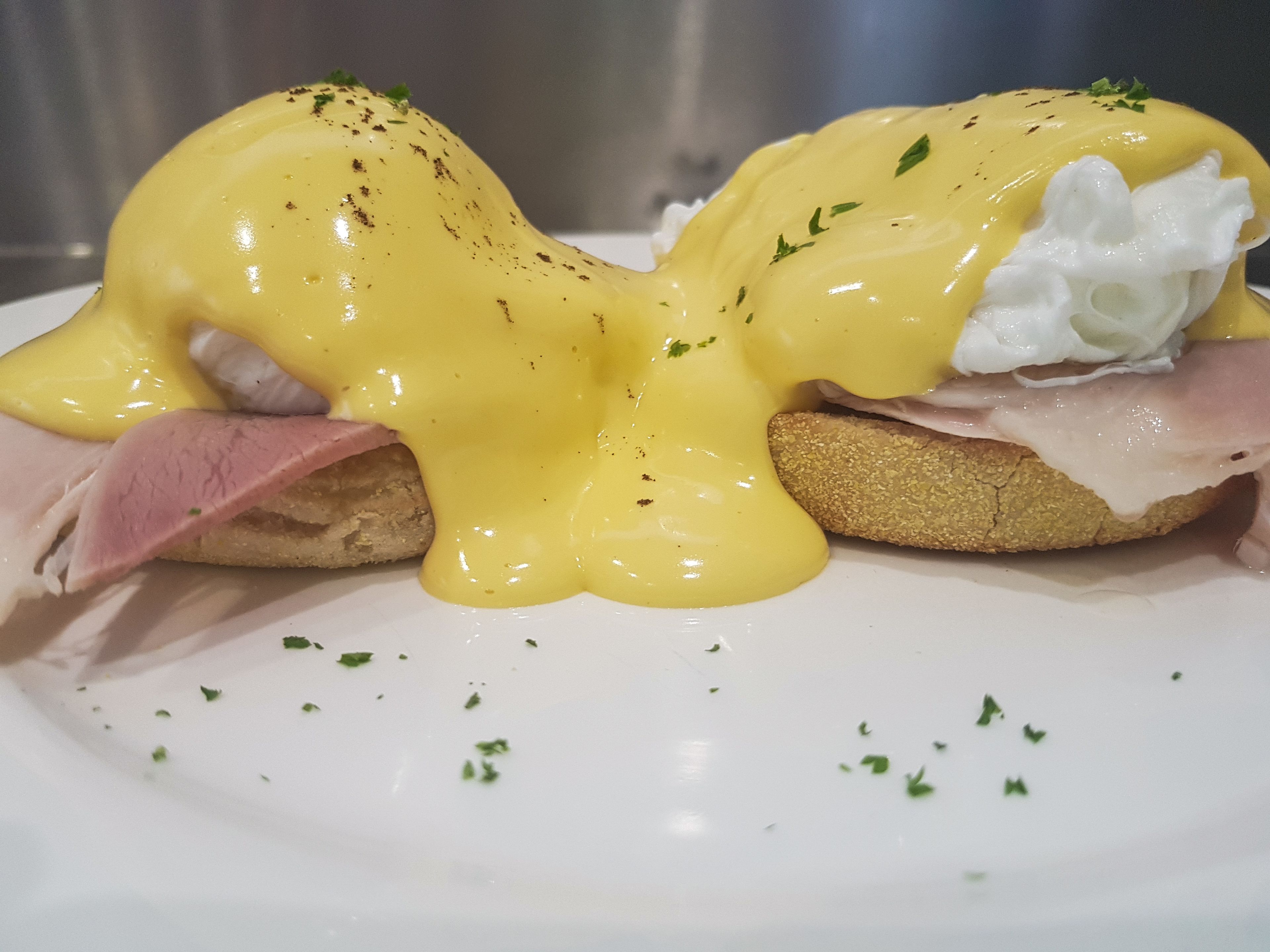 A breakfast dish with eggs, ham, and toast.