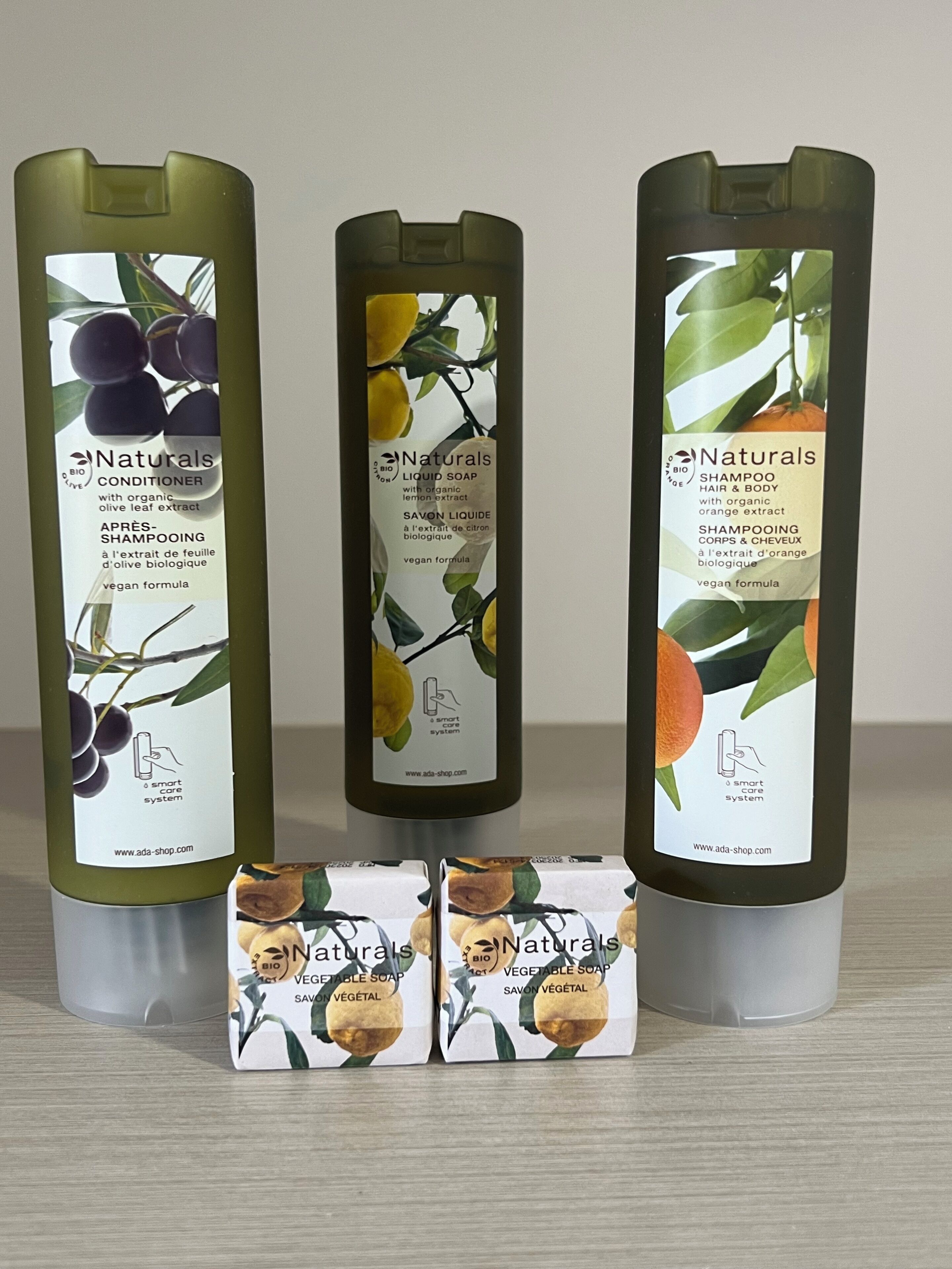 Three bottles of Naturals organic hair and body care products, and two boxes of Naturals vegetable soap.