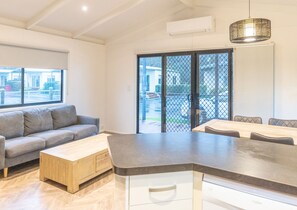 3 Bedroom Deluxe Villa | Living area | Flat-screen TV - NRMA Warrnambool Riverside Holiday Park (Allansford)