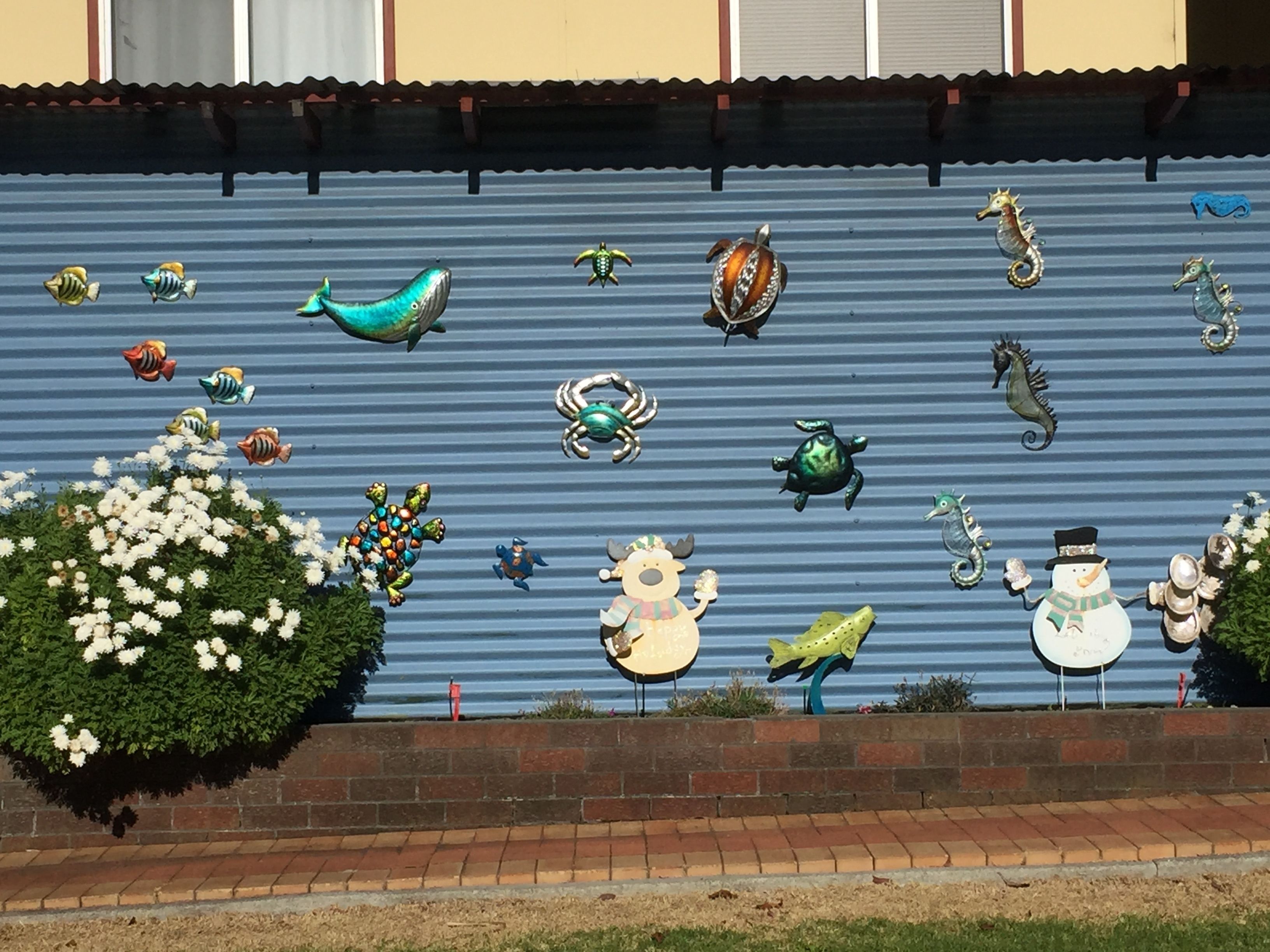 A decorative wall with various sea creature sculptures.