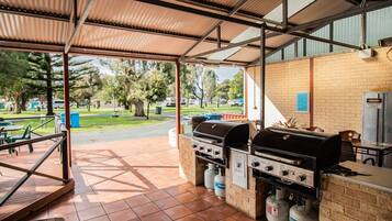 Enjoy al fresco dining at this outdoor barbecue area, featuring a gas grill and brick counter.