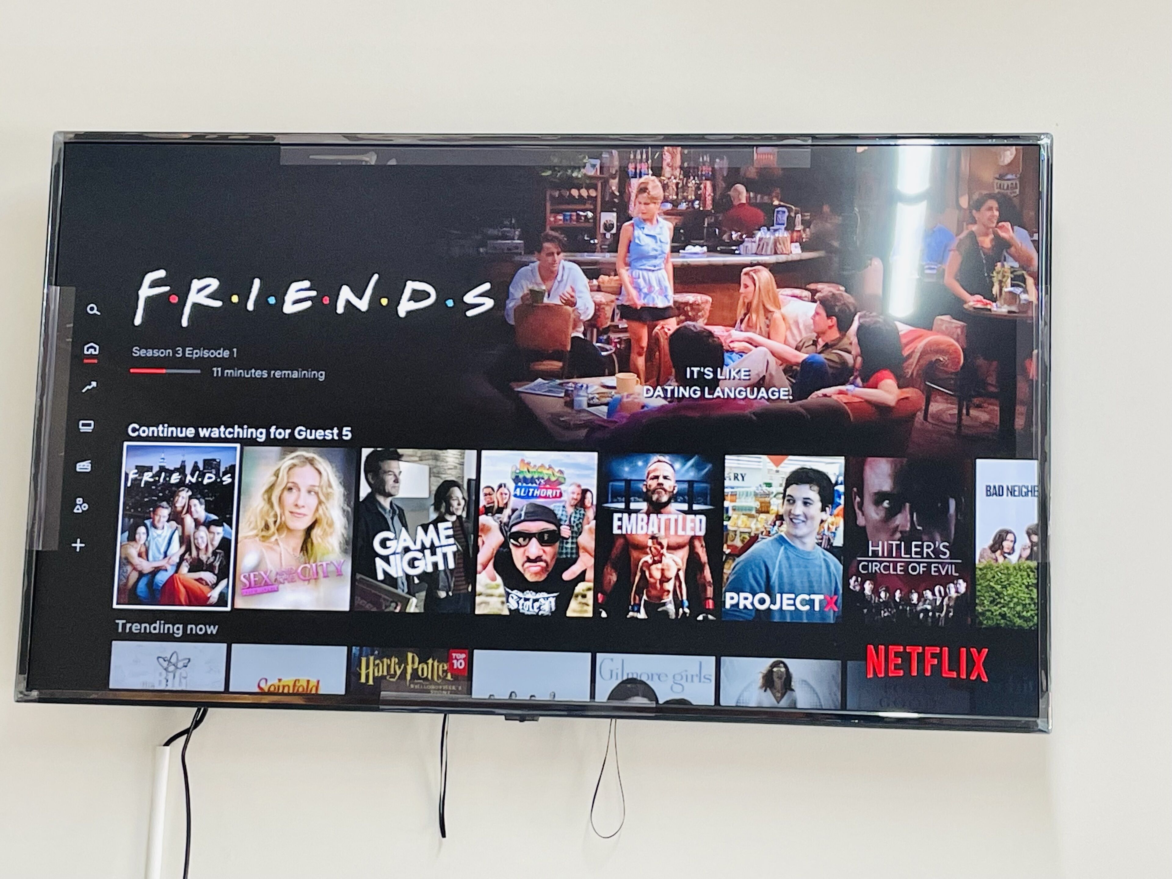 A television screen displaying a Netflix interface with the show 'Friends' highlighted, indicating Season 3 Episode 1 is playing.