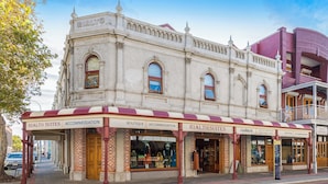 A historic building with multiple storefronts including 'Rialto Suites' and 'Accomodation'. - Rialto Suites (Fremantle)
