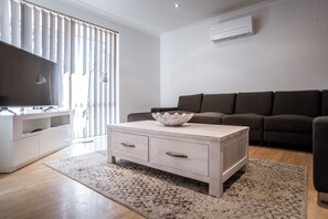 Lägenhet Deluxe - 3 sovrum - bubbelbad - bottenvåning | Vardagsrum | 106-centimeters platt-tv med digitalkanaler och tv