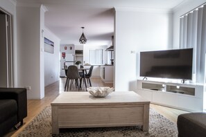 Deluxe Apartment, 3 Bedrooms, Jetted Tub, Ground Floor | Living area | 106-cm flat-screen TV with digital channels, TV