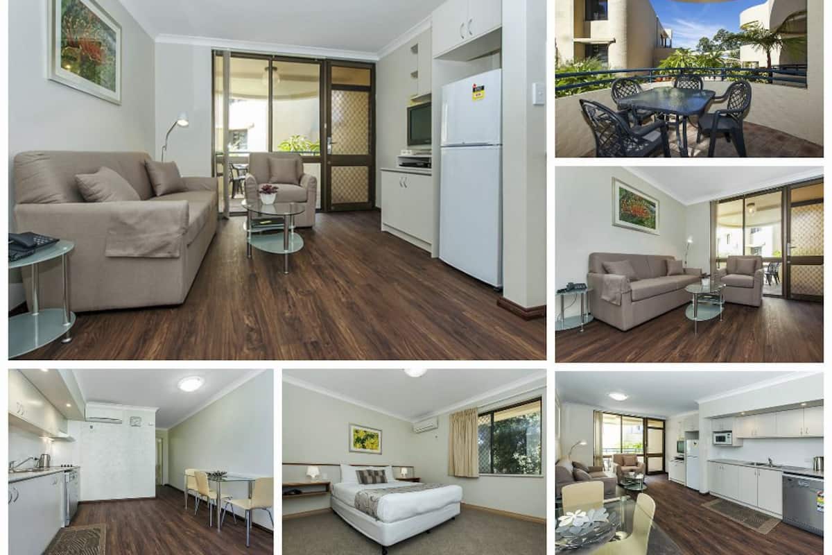 A modern apartment with a living room, dining area, kitchen, and balcony.