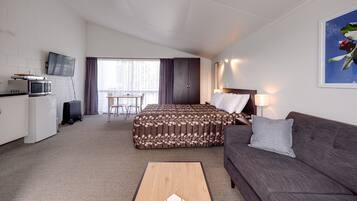 Standard Spacious Studio with Kitchenette | Living area | 32-inch flat-screen TV with satellite channels, TV