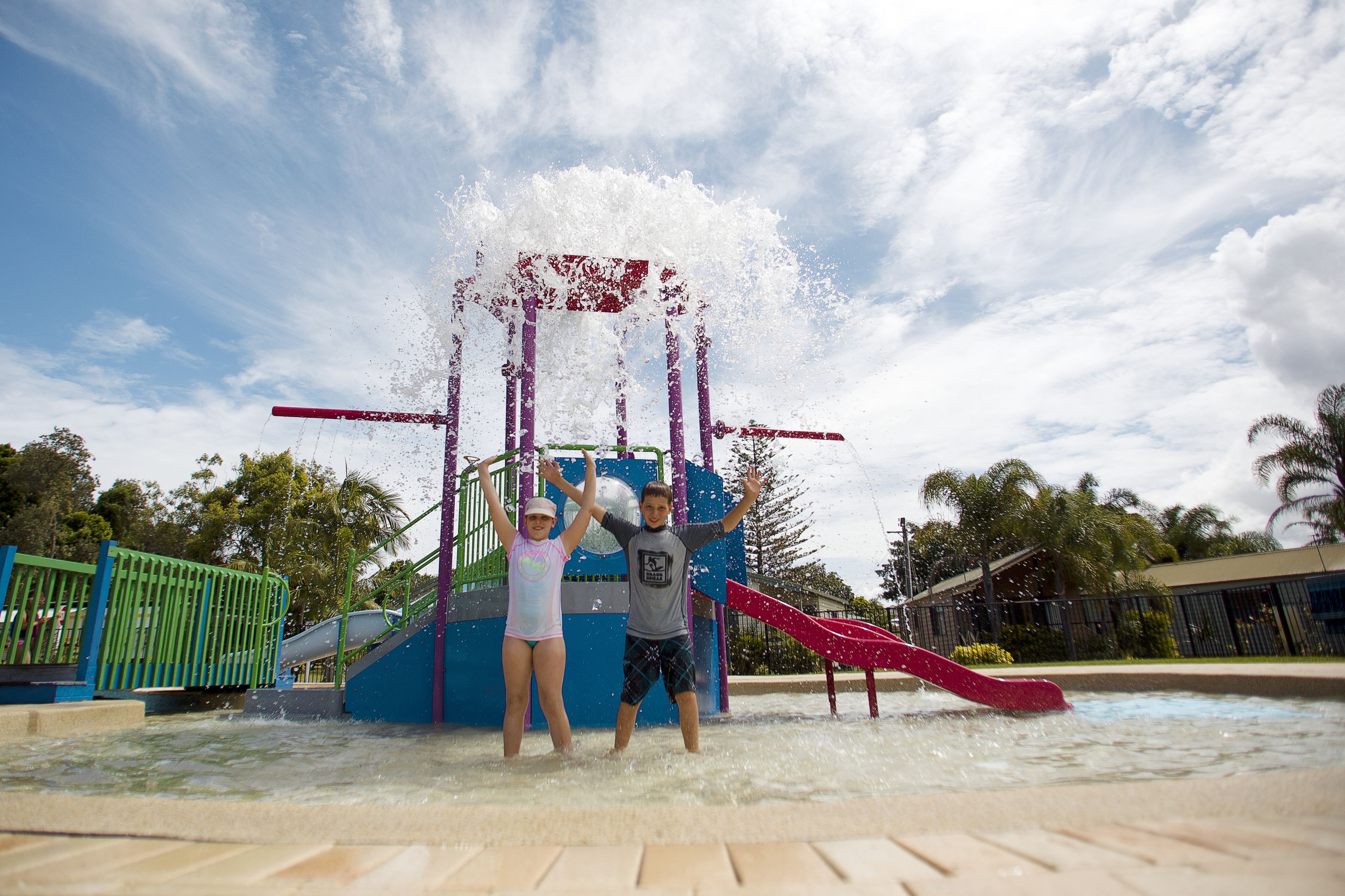 A water play area with a slide and a splash zone.