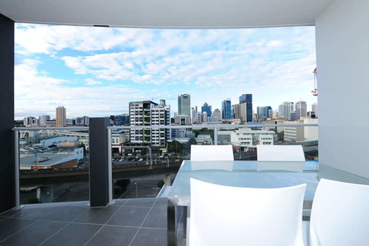 A modern dining area with a city skyline view.