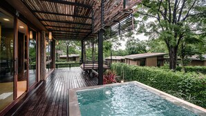 A wooden deck with a pool, surrounded by greenery and trees. - Mountain Creek Golf Resort & Residences (Sikhio)