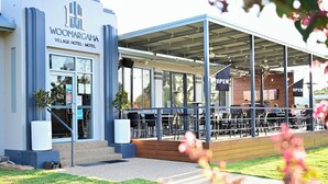 A modern hotel with a covered outdoor seating area. - Woomargama Village Hotel Motel (Woomargama)