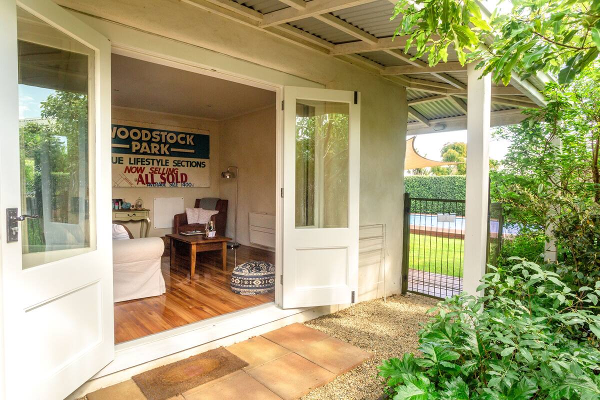 A property with a wooden deck, a white door, and a sign indicating the sale of all units.