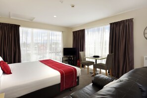A hotel room with a bed, a desk, a chair, and a couch. - 171 On High Motel (Blenheim)