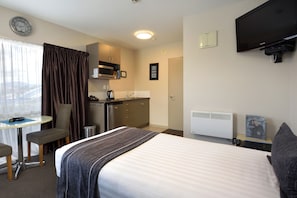One Bedroom Standard Suite | Living area | 32-inch Smart TV with satellite channels, TV