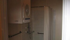A small, enclosed shower area with a handheld showerhead, a towel rack, and a toilet. - South Hedland Motel (South Hedland)