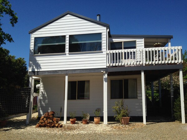 A two-story house with a balcony, large windows, and a covered porch area. - Yarraglen BnB (Yarra Glen)